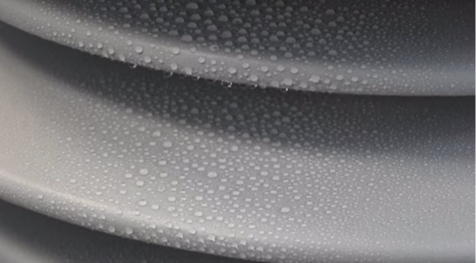 Hydrophobicity testing of an RTV-coated ceramic post insulator for a HDVC reactor - shows water droplets on an insulator surface